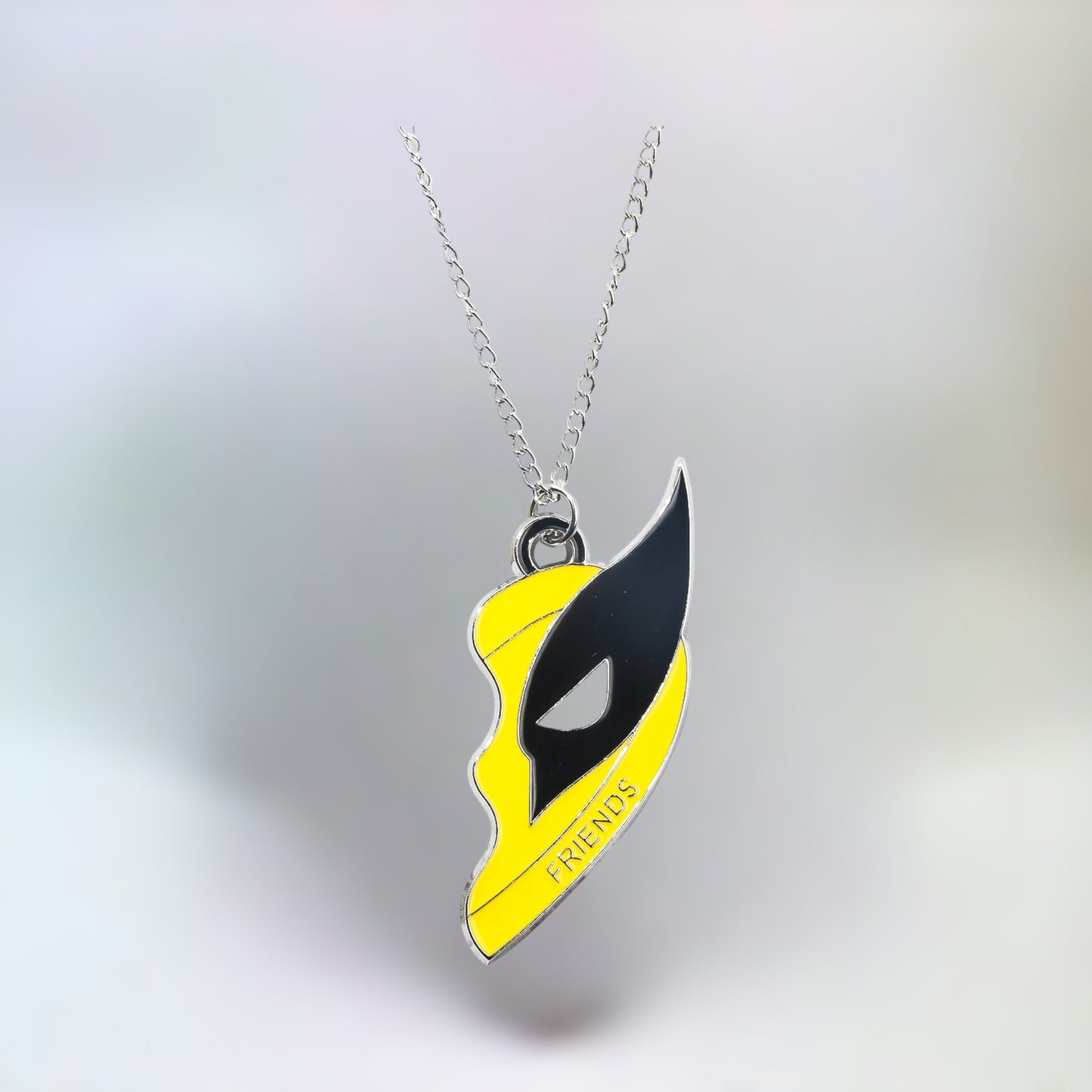 Close-up of the Wolverine pendant from the Deadpool and Wolverine best friends necklace on a plain white background.