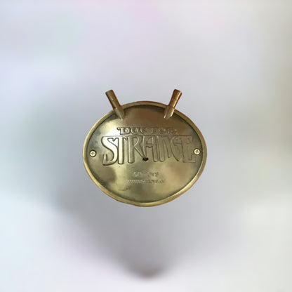 Doctor Strange Eye of Agamotto Necklace pendant back side on a plain white background.