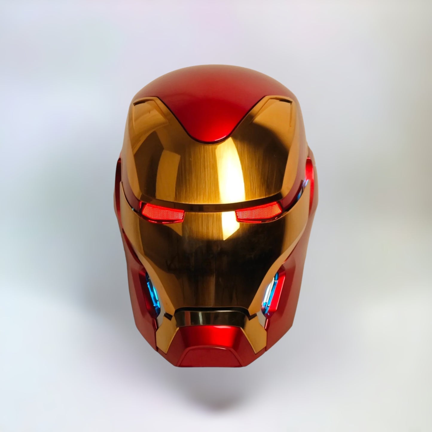 Iron Man MK50 Helmet front side with red lights on a plain background.