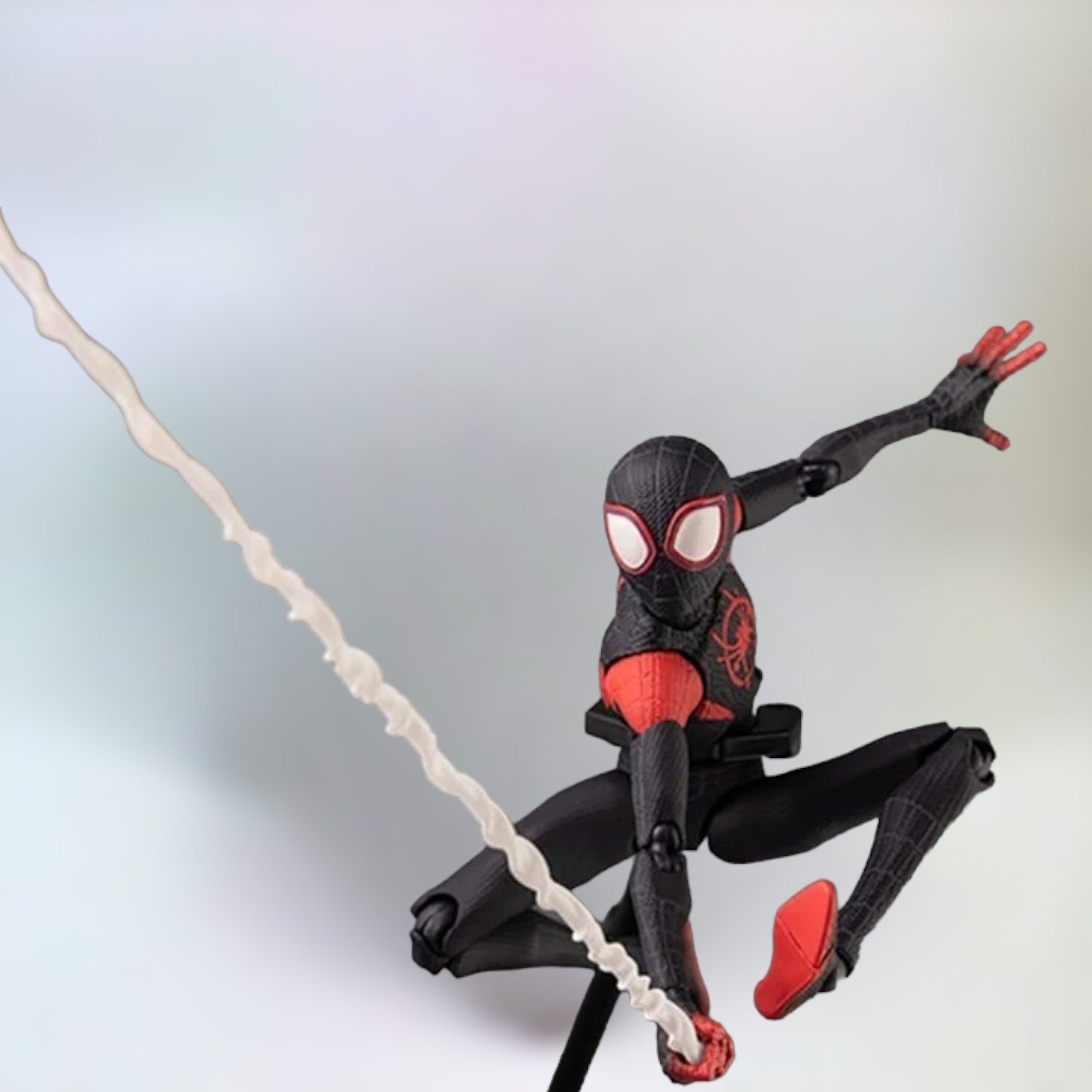 Miles Morales action figure on display stand swinging with a plain white background.