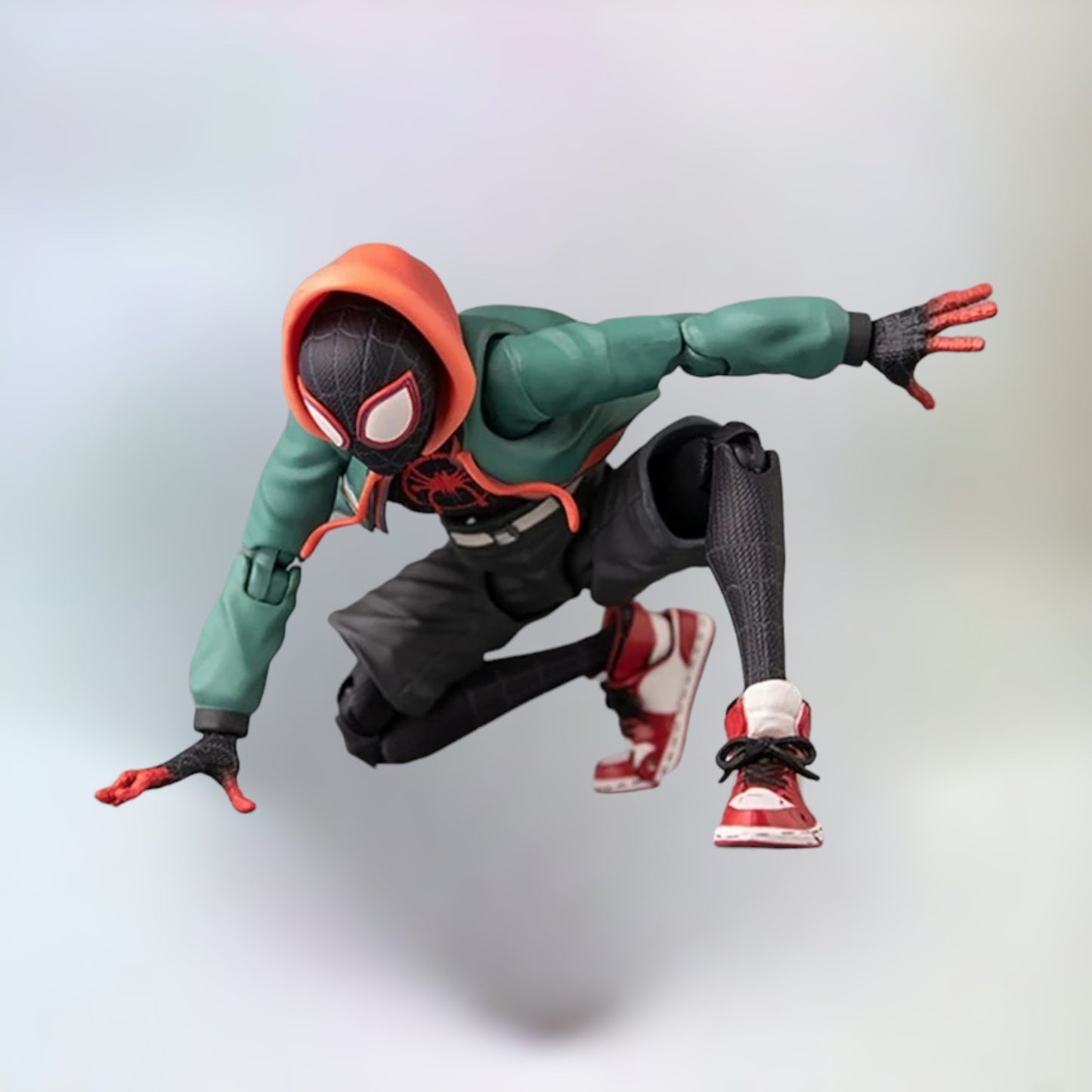 Miles Morales action figure in the iconic spiderman pose with a plain white background.