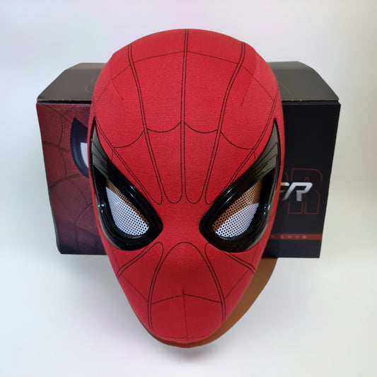 Spiderman mask blinking eyes movable remote control in front of box on a plain white background.