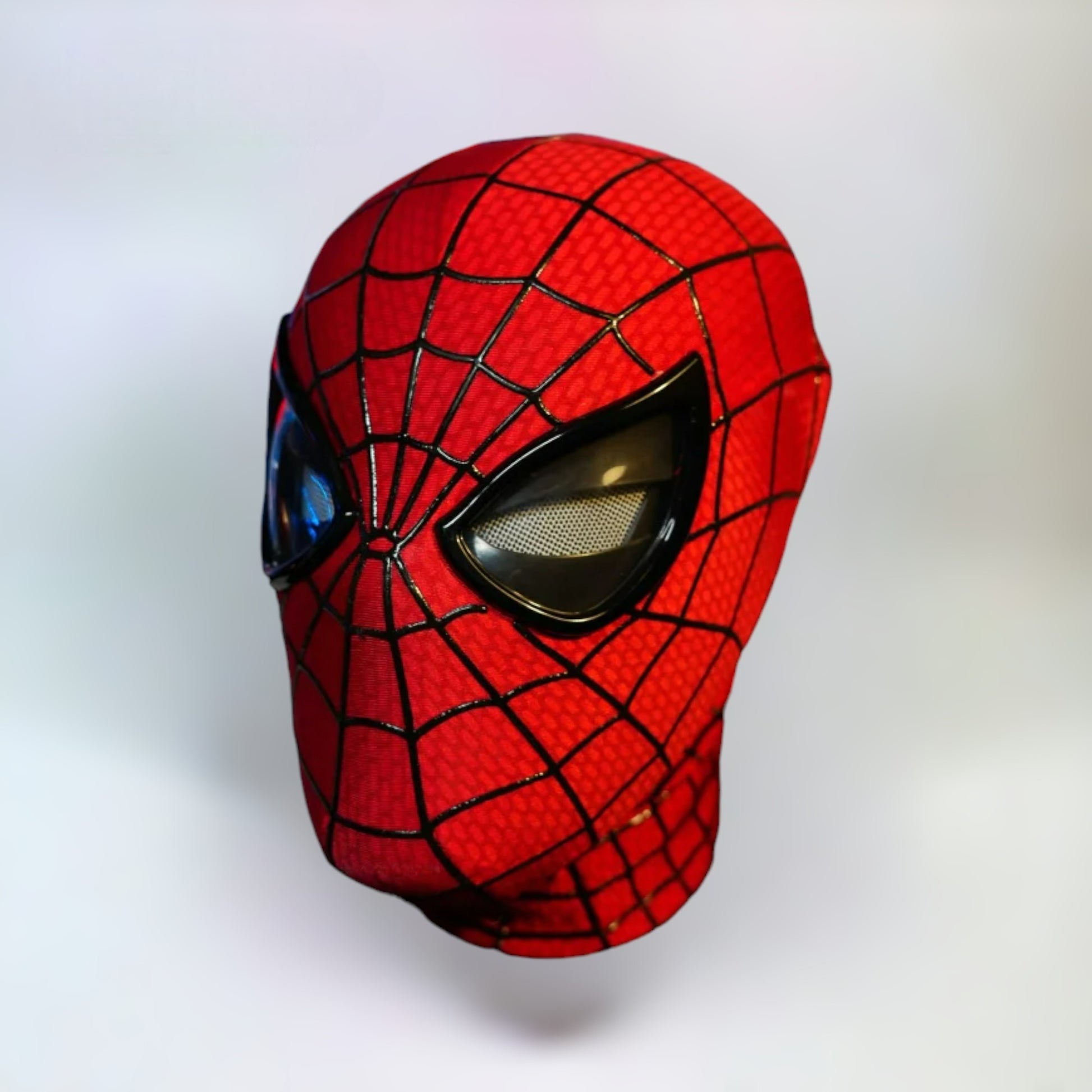 The Amazing Spiderman Mask with Blinking Movable Eyes Remote Controlled and LED Lights Side View. Spiderman mask with plain white background