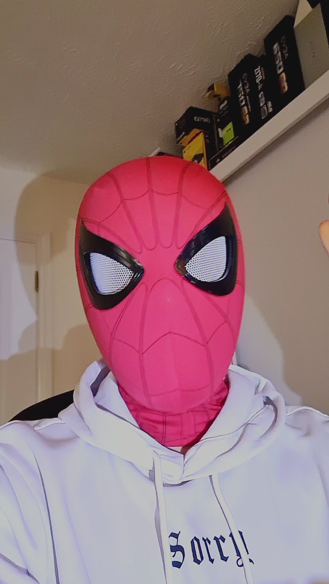 Spiderman mask with movable eyes blinking, remote control being used. Spiderman mask remote control version testing video.